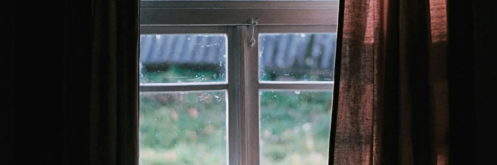 Two mugs on a sunlit windowsill